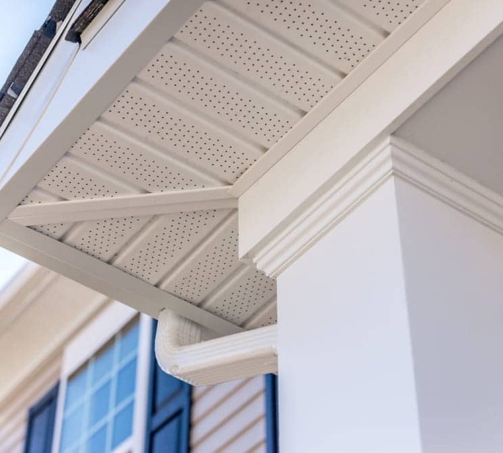 Colonial white custom porch columns with wood looking vinyl column wrap, sheets and molding. White soffit provides optimal ventilation for roof overhangs